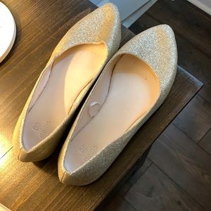 Gold sparkly flats.